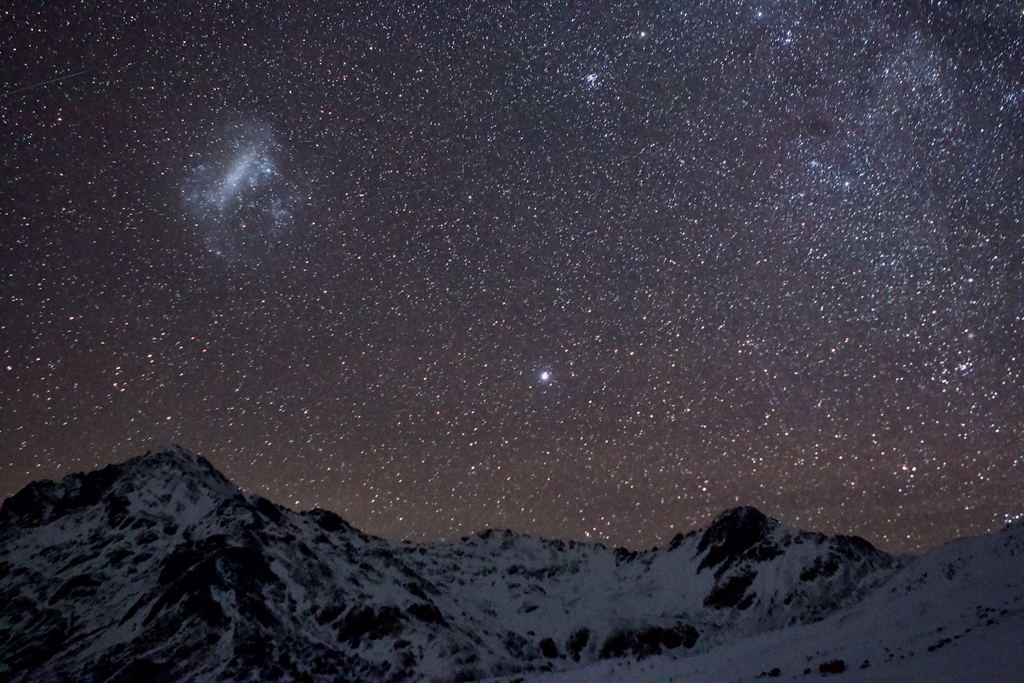 The Large Magellanic Cloud over Maniniaro/Angelus Peak, and the star Canopus glowing brightly to the right of Sunset Saddle.